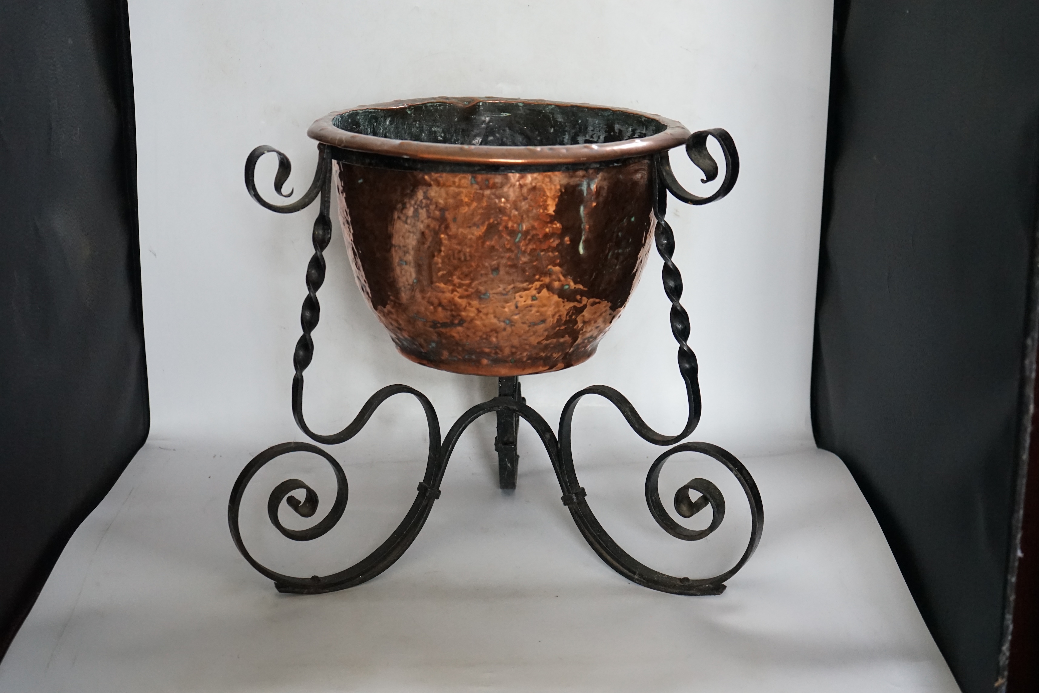 An Edwardian wrought iron and copper jardiniere